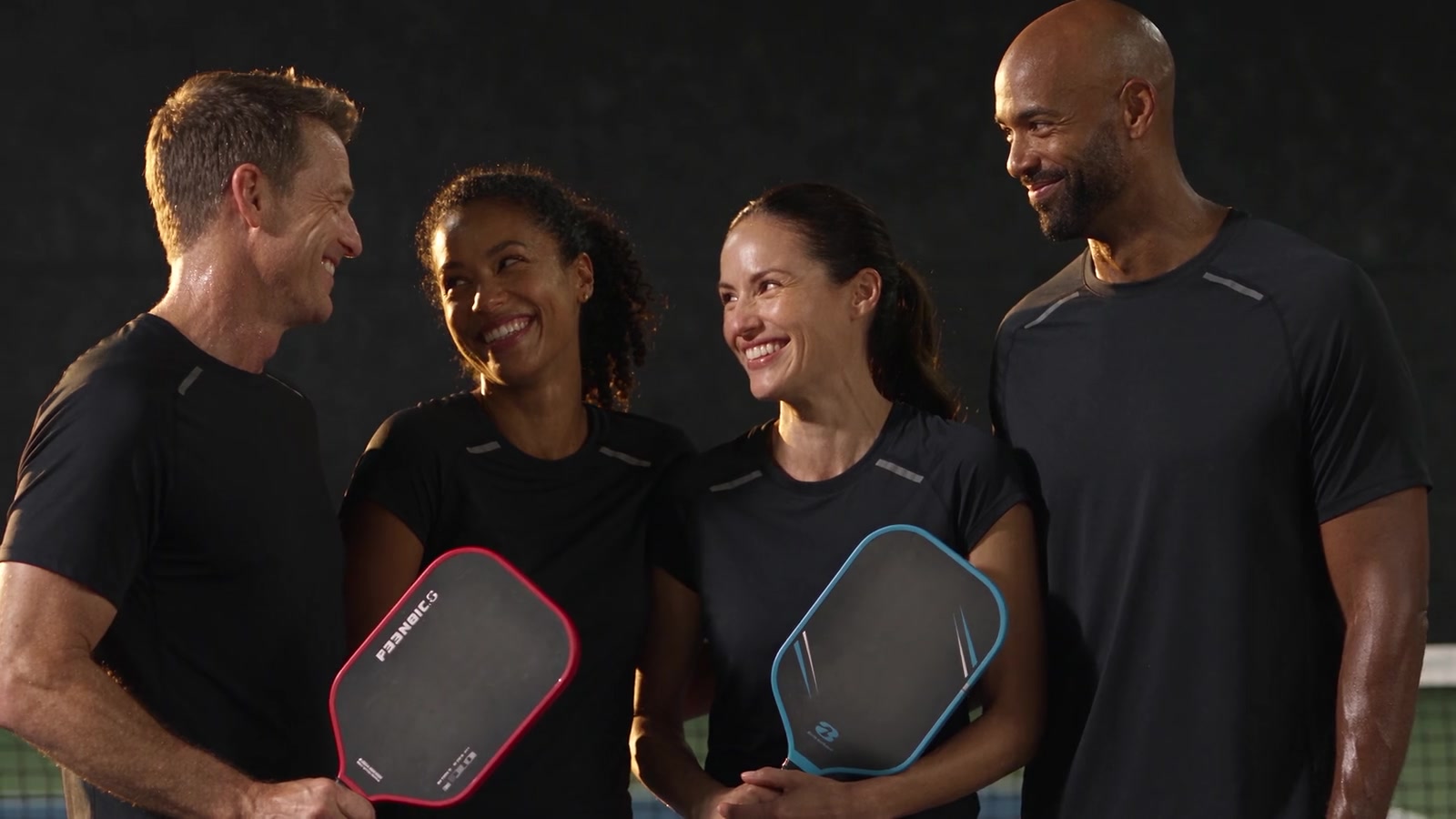 Friends laughing together after a game of pickleball