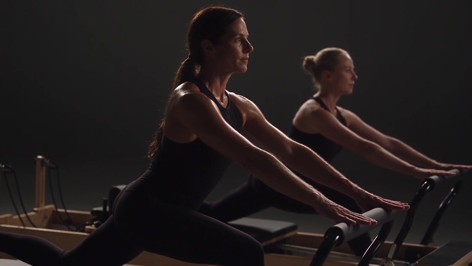 Two women sharing a focused Pilates session