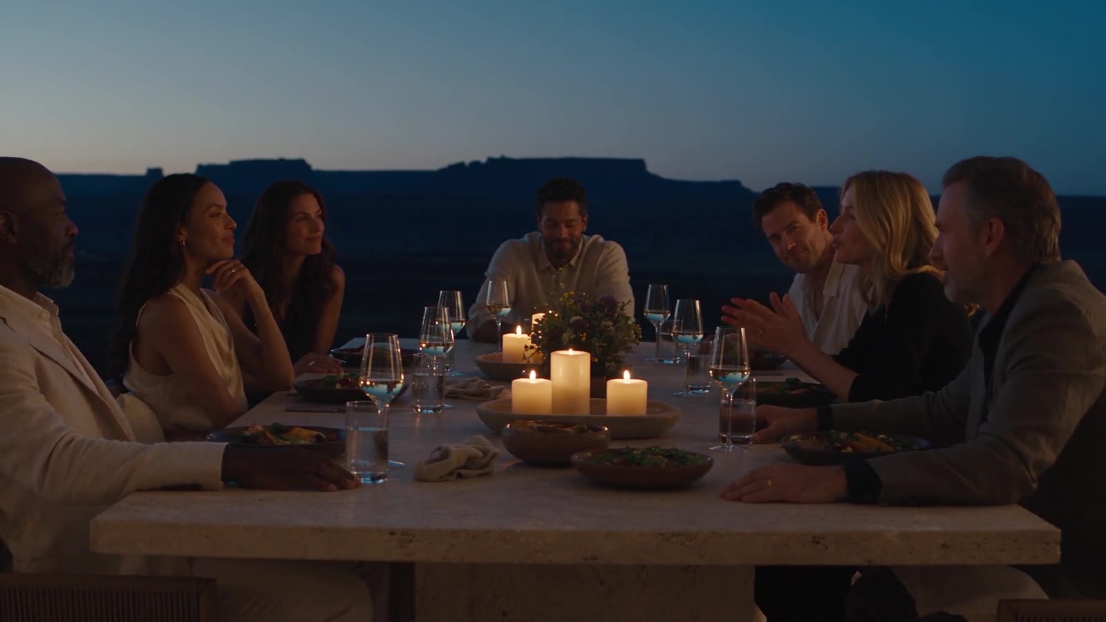 A circle of friends sharing a dinner and conversation